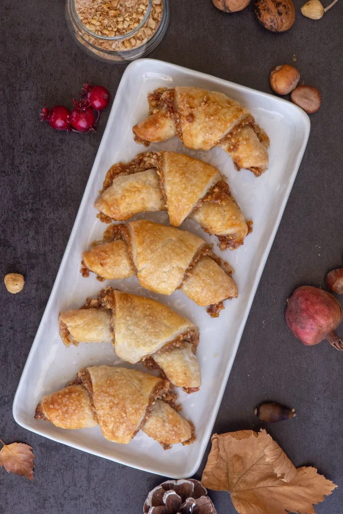 Golden rugelach cookies filled with nuts and sweet cinnamon filling