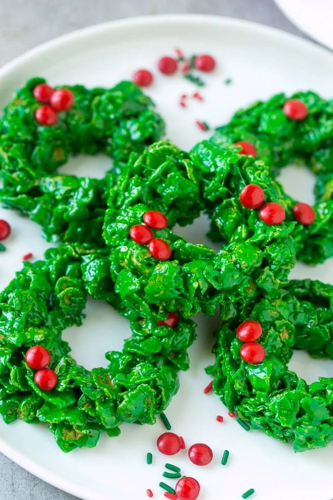 Christmas wreath cookies decorated with green icing and festive sprinkles