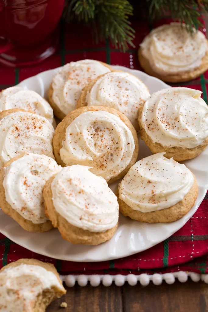 Festive eggnog cookies topped with creamy icing and nutmeg