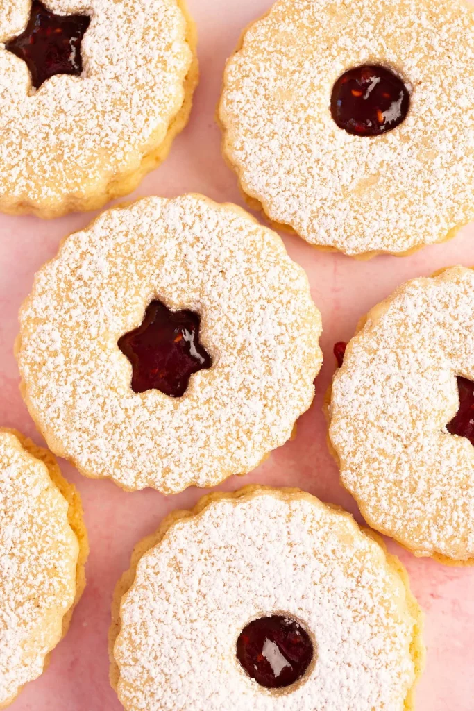 Linzer cookies filled with raspberry jam and dusted with powdered sugar