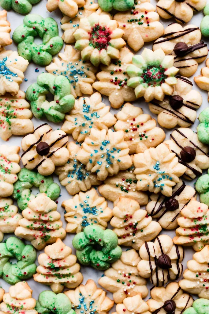Festive spritz cookies decorated with colorful Christmas sprinkles