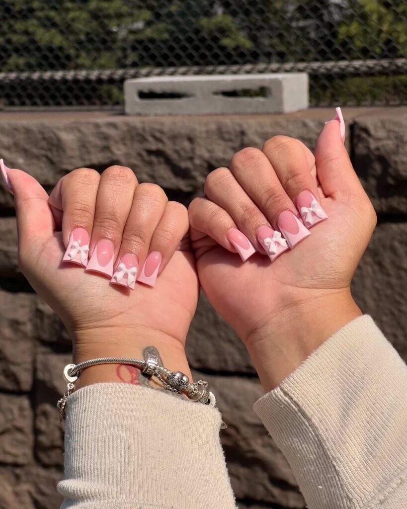 A bold collection of duck nails featuring glitter, ombre designs, and rhinestone accents on duck-tip acrylic nails.