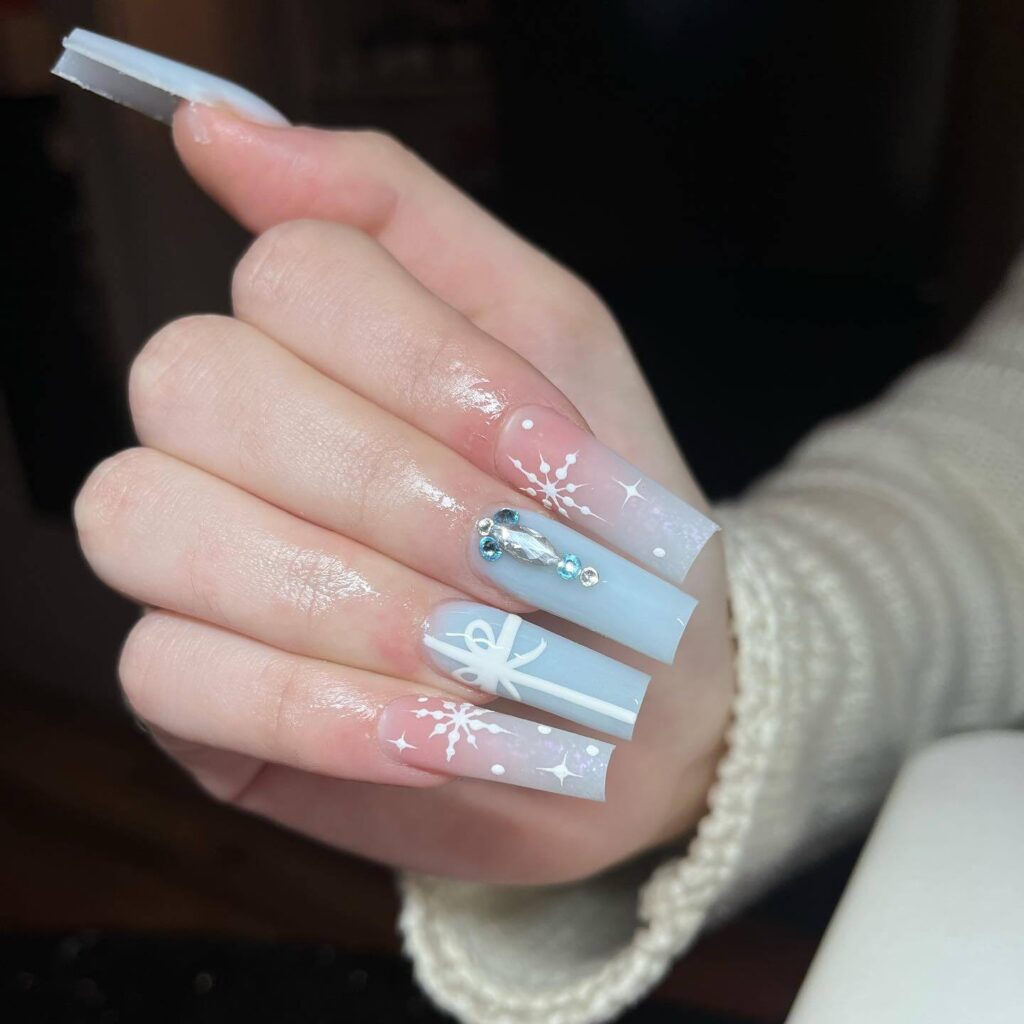 A collection of light blue nails with ombre nail designs, glitter accents, and unique floral patterns showcasing creativity and style.