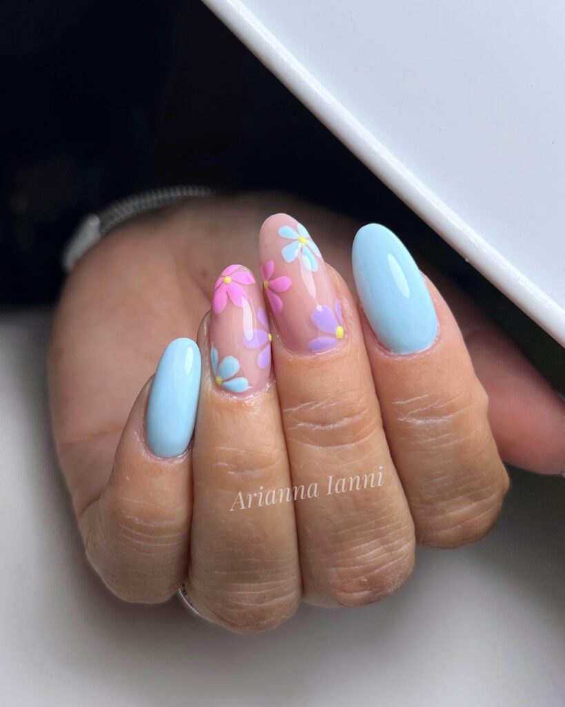 A collection of light blue nails with ombre nail designs, glitter accents, and unique floral patterns showcasing creativity and style.