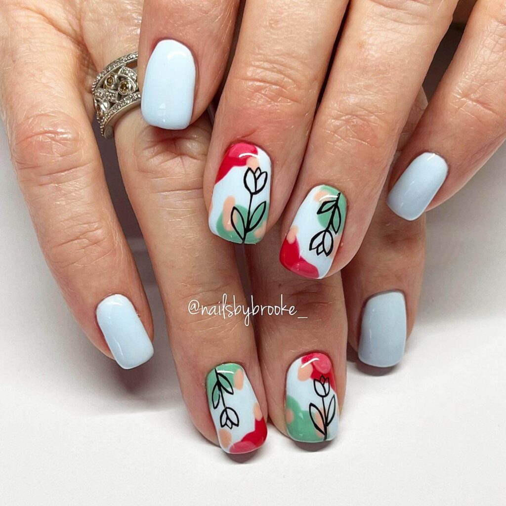 A collection of light blue nails with ombre nail designs, glitter accents, and unique floral patterns showcasing creativity and style.