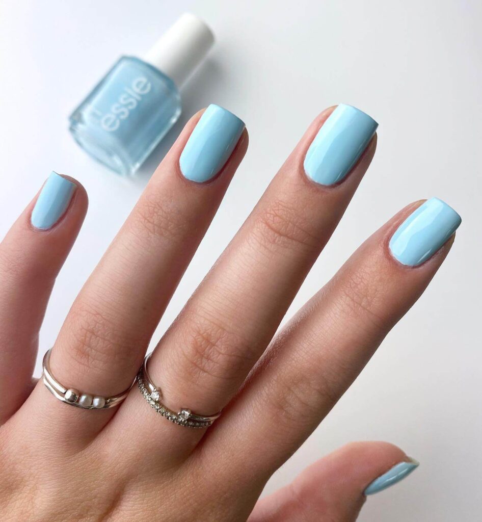 A collection of light blue nails with ombre nail designs, glitter accents, and unique floral patterns showcasing creativity and style.