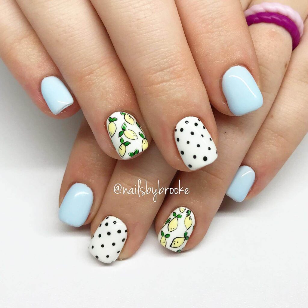 A collection of light blue nails with ombre nail designs, glitter accents, and unique floral patterns showcasing creativity and style.