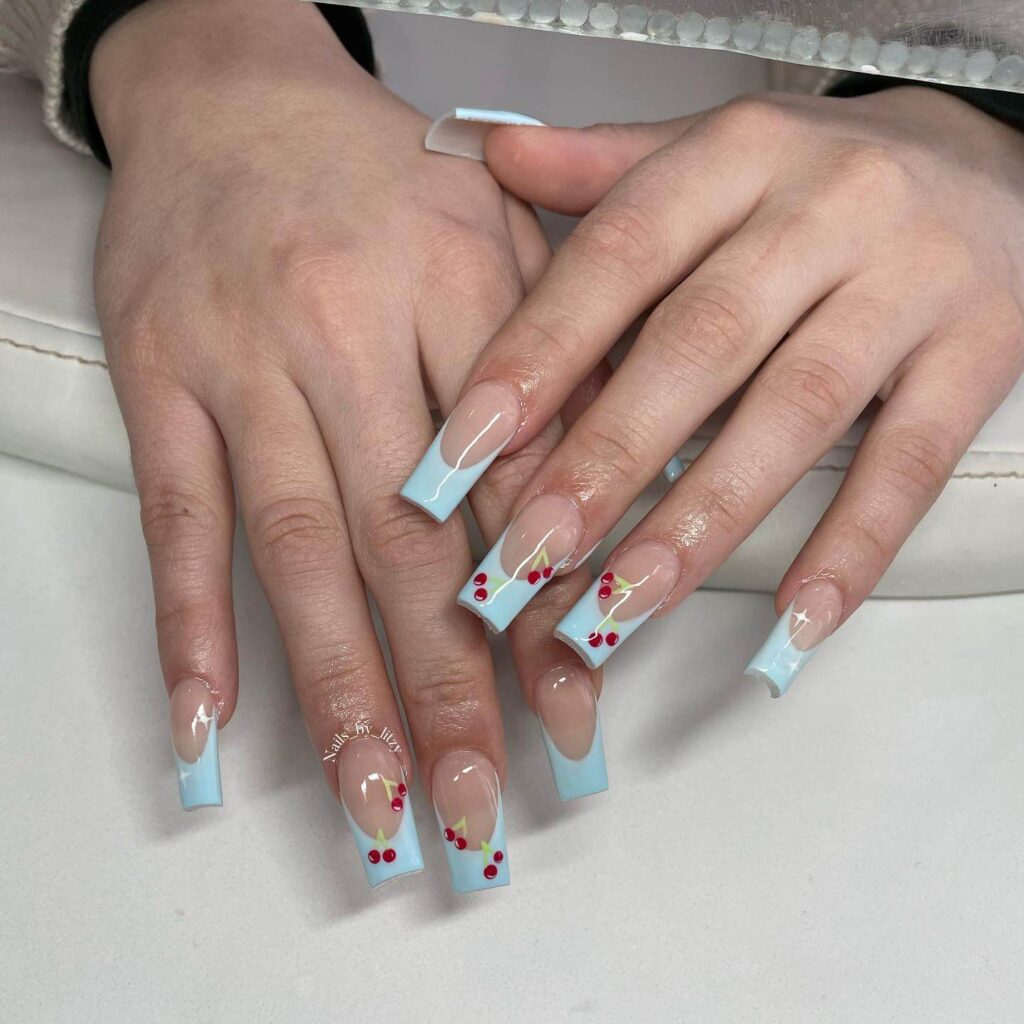 A collection of light blue nails with ombre nail designs, glitter accents, and unique floral patterns showcasing creativity and style.