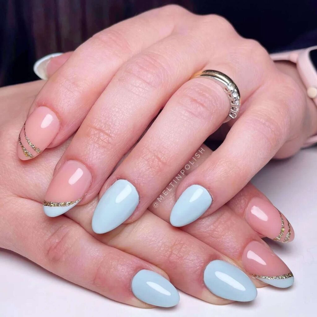 A collection of light blue nails with ombre nail designs, glitter accents, and unique floral patterns showcasing creativity and style.