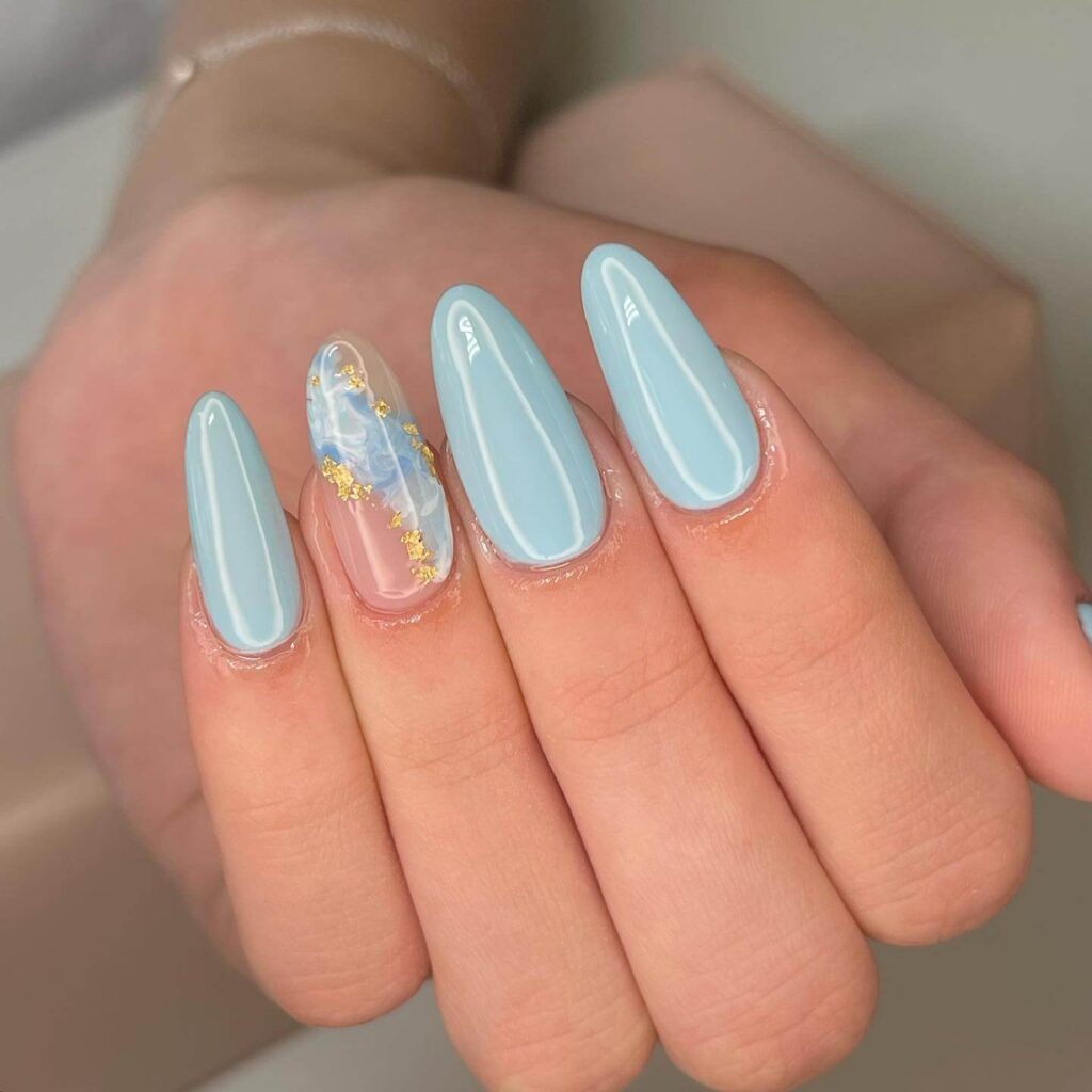 A collection of light blue nails with ombre nail designs, glitter accents, and unique floral patterns showcasing creativity and style.