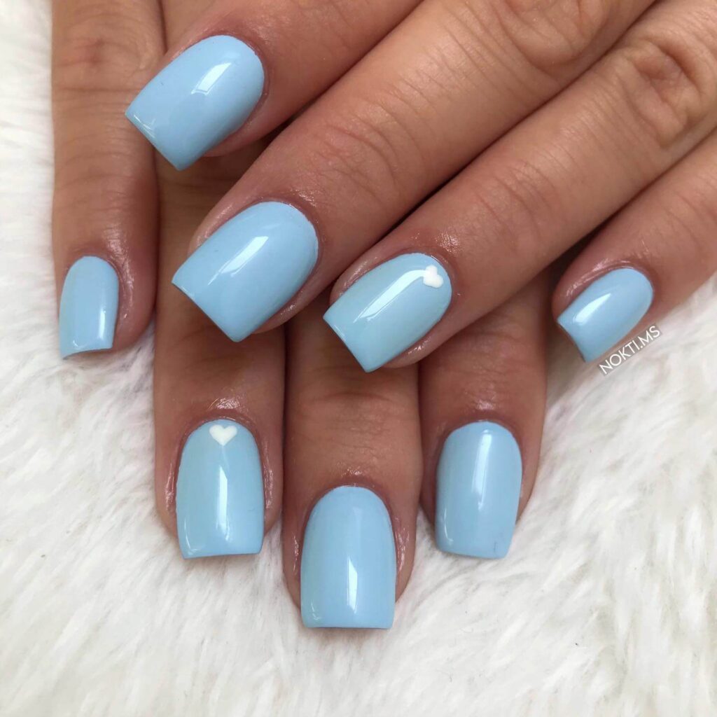 A collection of light blue nails with ombre nail designs, glitter accents, and unique floral patterns showcasing creativity and style.