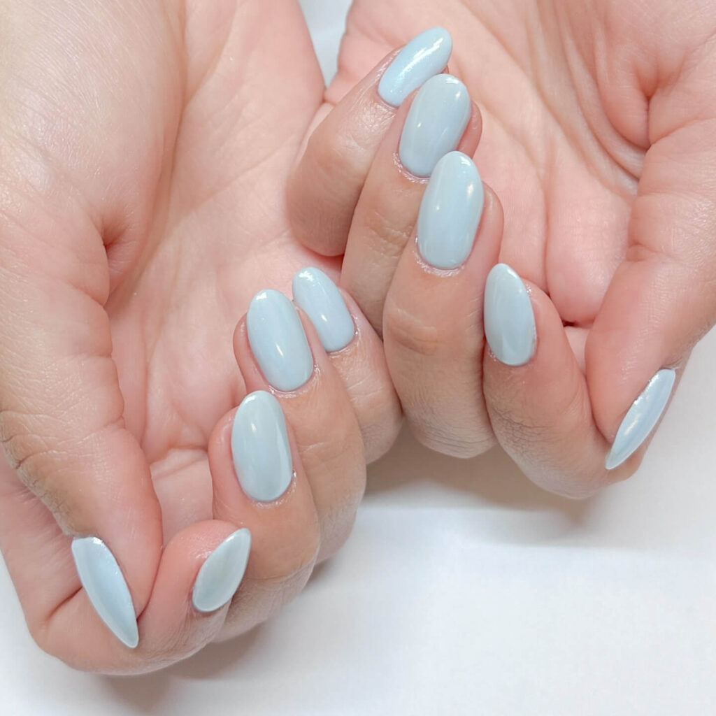 A collection of light blue nails with ombre nail designs, glitter accents, and unique floral patterns showcasing creativity and style.