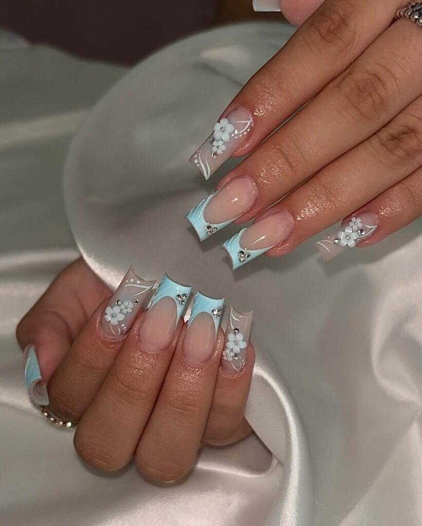 A collection of light blue nails with ombre nail designs, glitter accents, and unique floral patterns showcasing creativity and style.