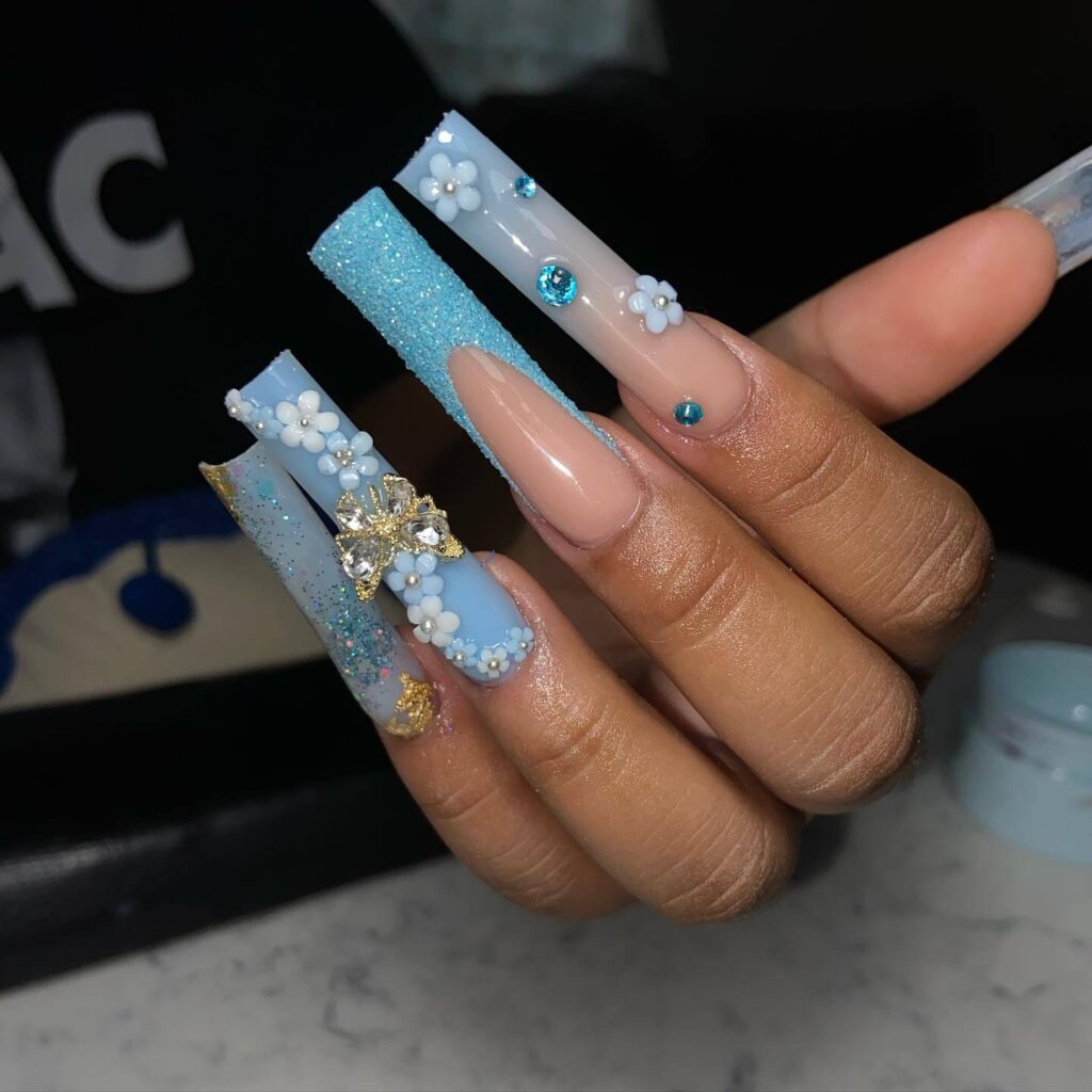 A collection of light blue nails with ombre nail designs, glitter accents, and unique floral patterns showcasing creativity and style.