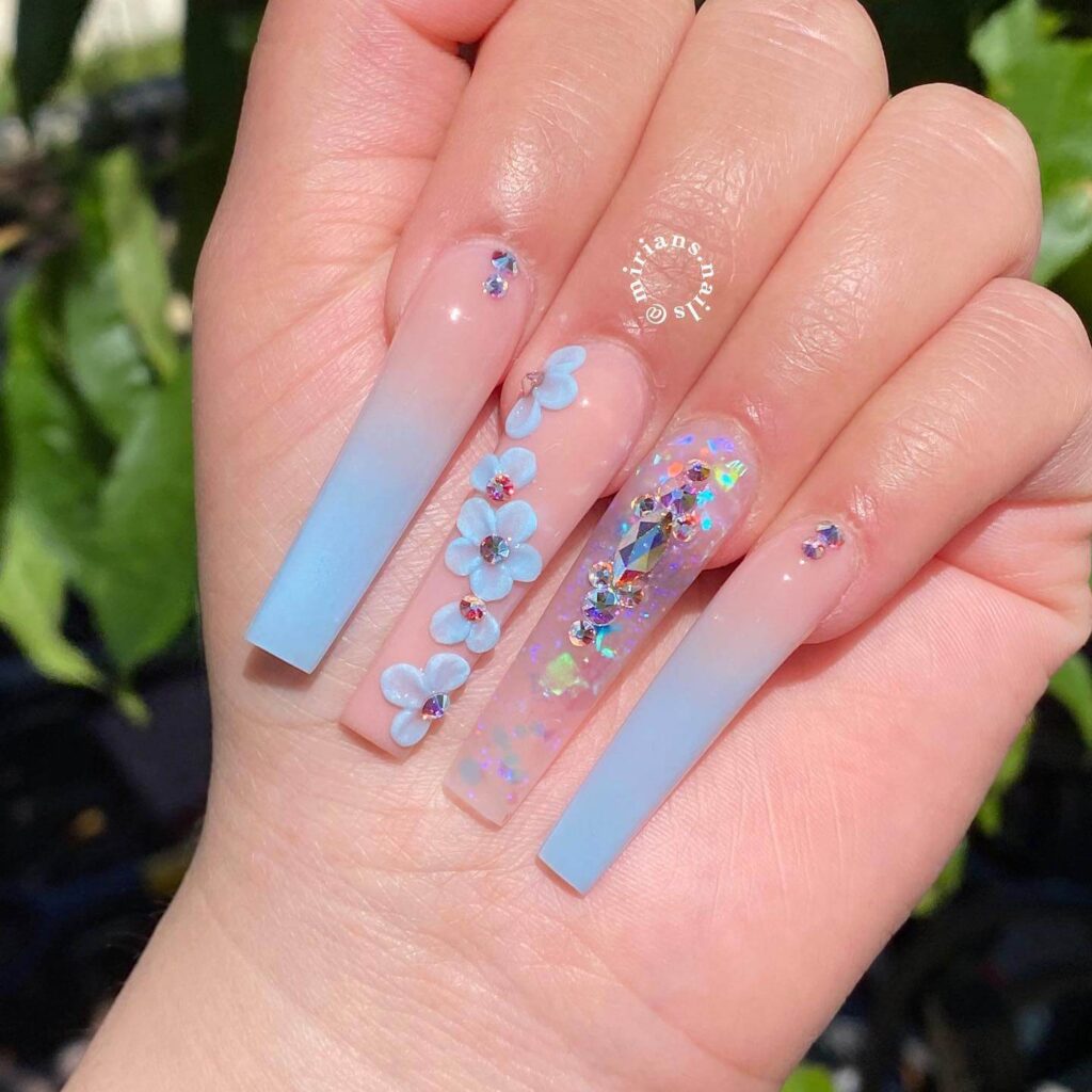 A collection of light blue nails with ombre nail designs, glitter accents, and unique floral patterns showcasing creativity and style.