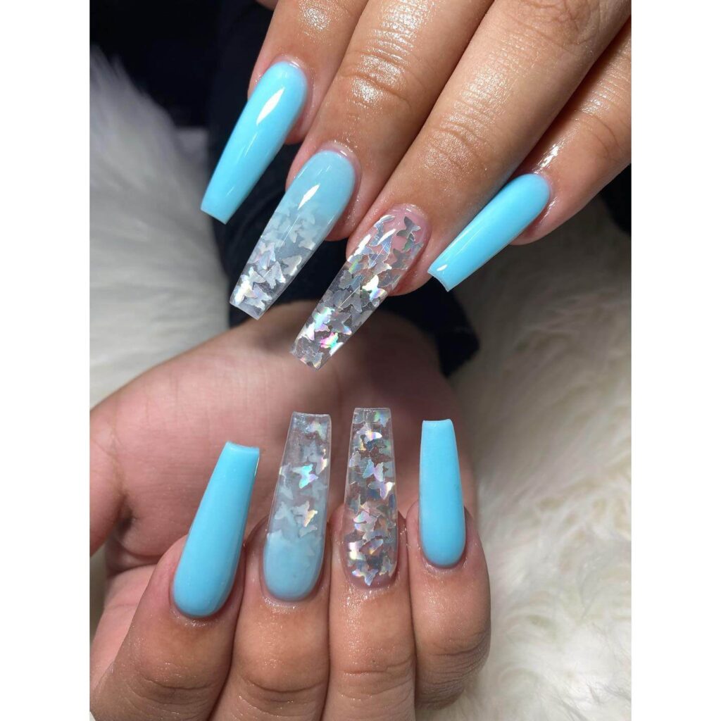 A collection of light blue nails with ombre nail designs, glitter accents, and unique floral patterns showcasing creativity and style.