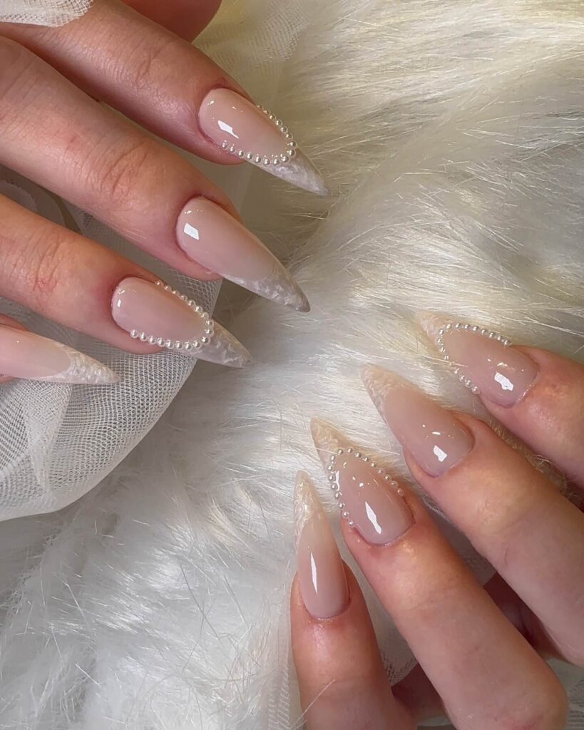 Elegant pearl nails featuring natural to acrylic designs, explore pearl nails for weddings, proms, and formal occasions.