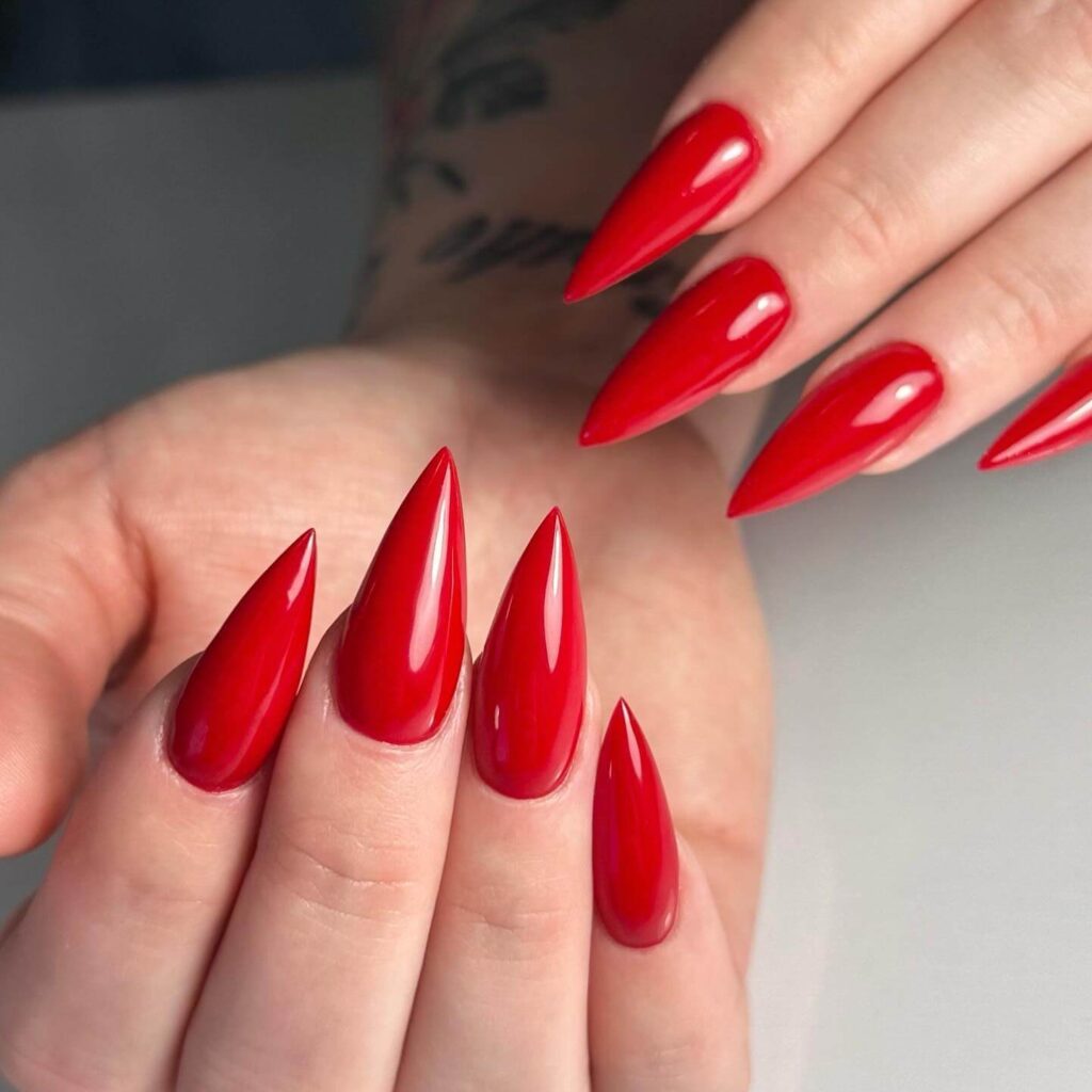 A collection of stiletto nails featuring bold designs, from acrylic and minimalist to glitter and ombre finishes for a dramatic and elegant manicure. 