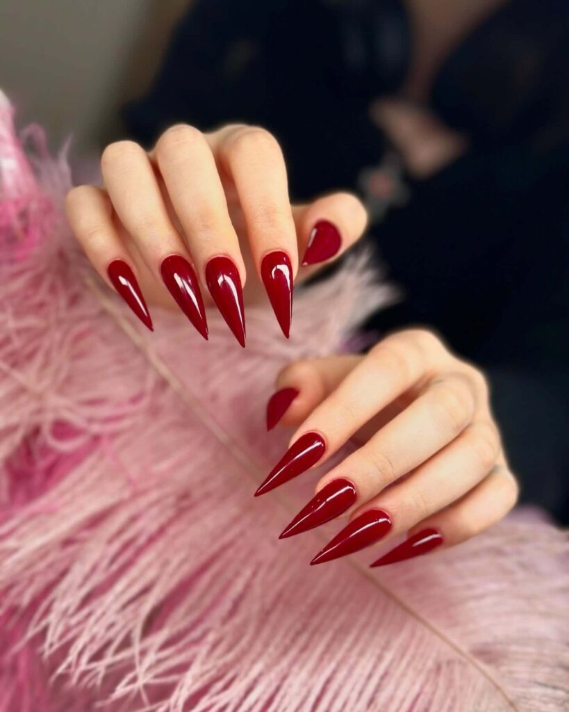 A collection of stiletto nails featuring bold designs, from acrylic and minimalist to glitter and ombre finishes for a dramatic and elegant manicure. 