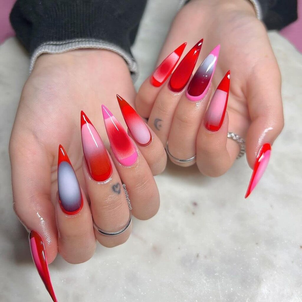 A collection of stiletto nails featuring bold designs, from acrylic and minimalist to glitter and ombre finishes for a dramatic and elegant manicure. 