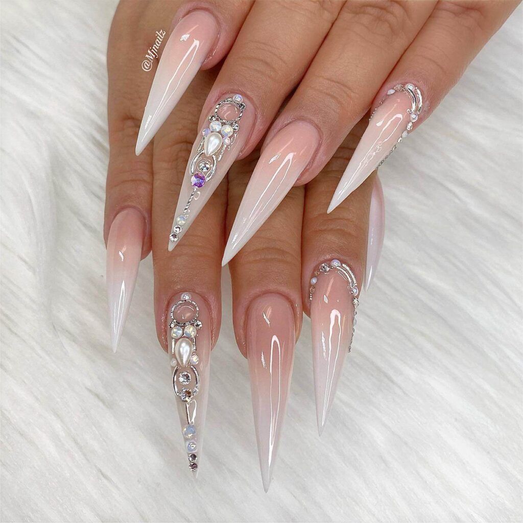 A collection of stiletto nails featuring bold designs, from acrylic and minimalist to glitter and ombre finishes for a dramatic and elegant manicure. 