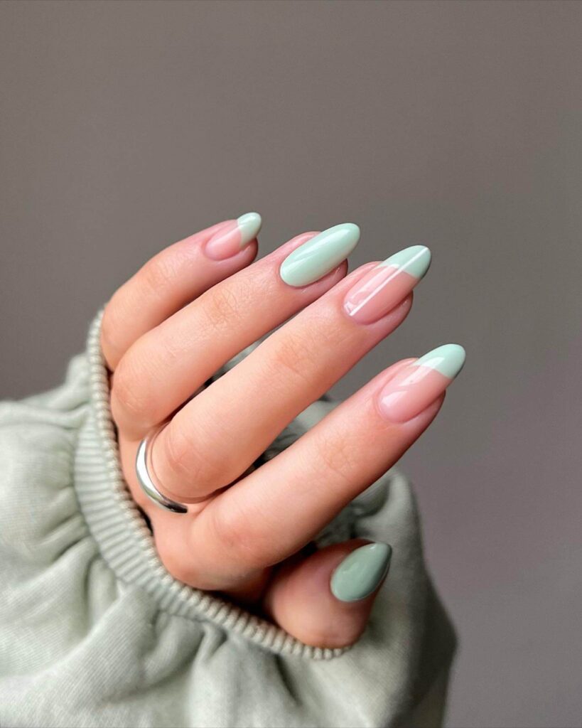 Freshly painted sage green nails with a minimalist design. This muted green nail polish trend is perfect for a subtle, nature-inspired manicure.