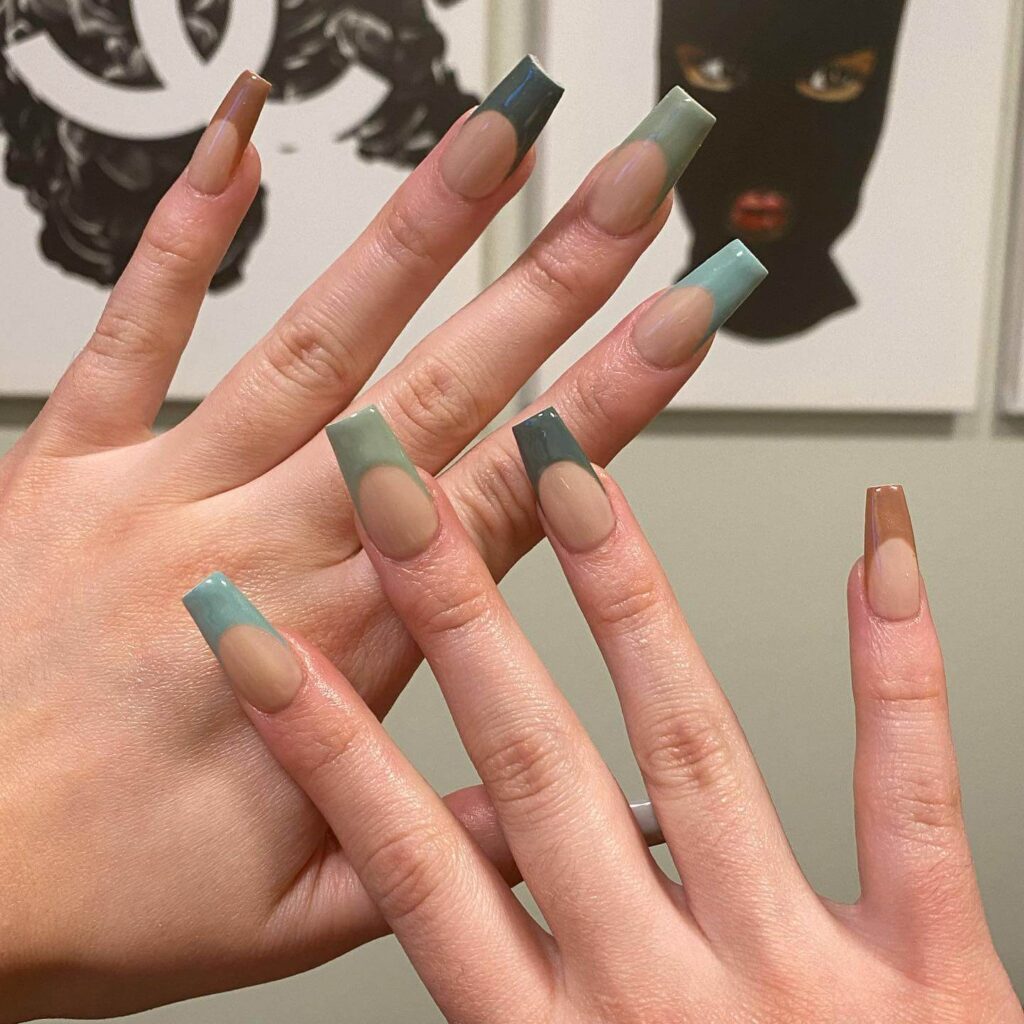 Freshly painted sage green nails with a minimalist design. This muted green nail polish trend is perfect for a subtle, nature-inspired manicure.