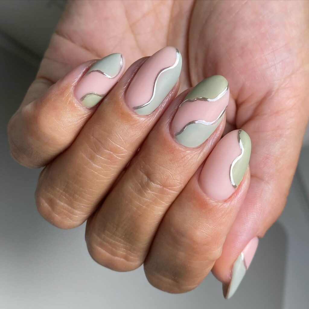 Freshly painted sage green nails with a minimalist design. This muted green nail polish trend is perfect for a subtle, nature-inspired manicure.