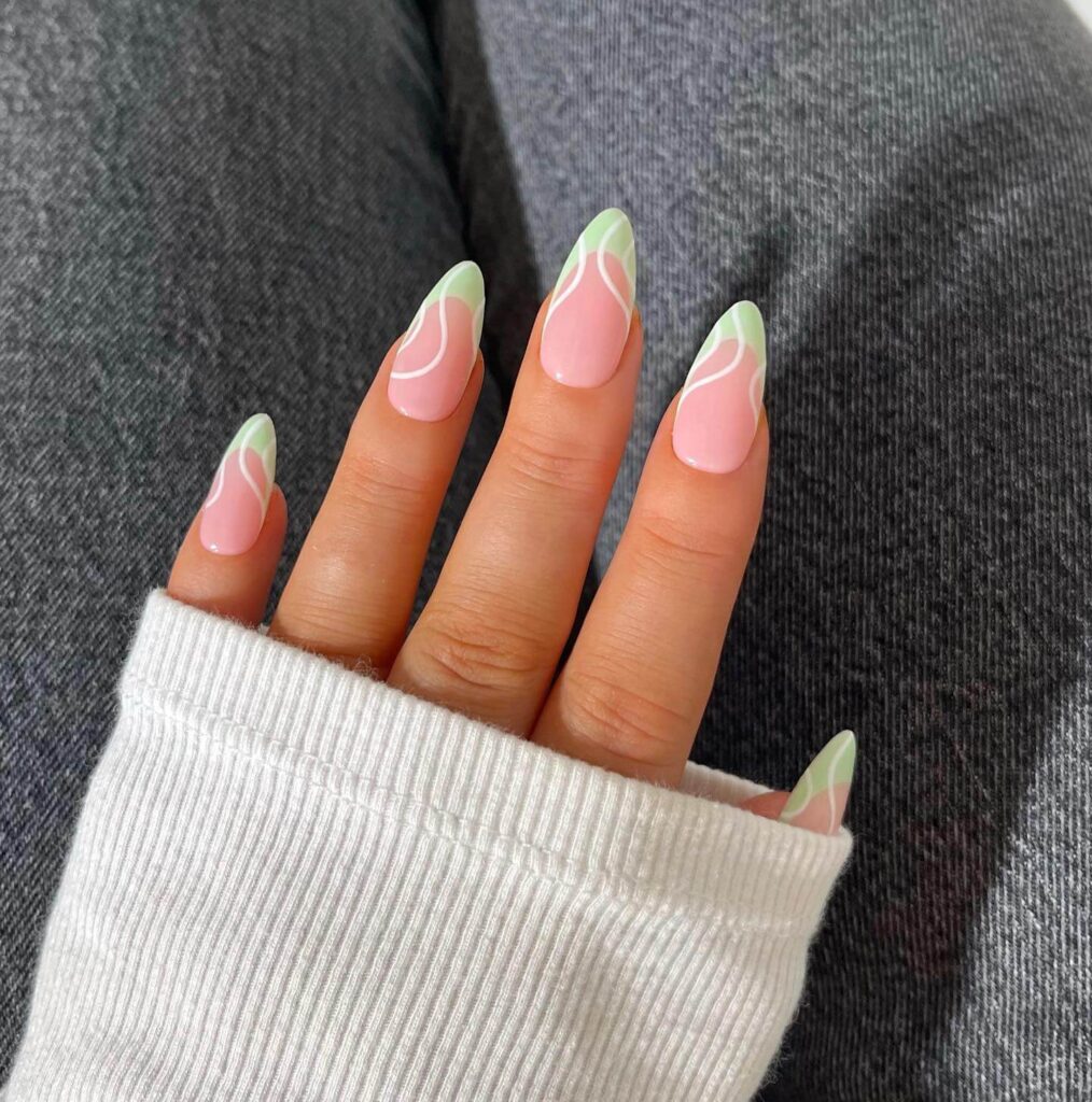 Freshly painted sage green nails with a minimalist design. This muted green nail polish trend is perfect for a subtle, nature-inspired manicure.