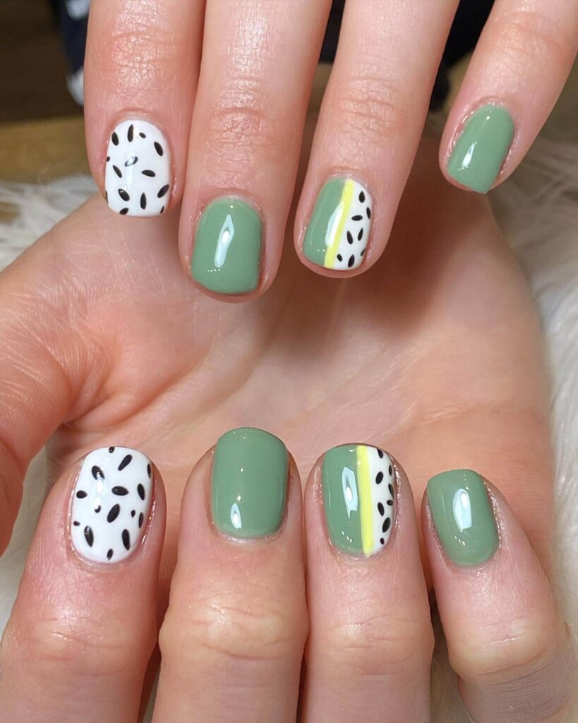 Freshly painted sage green nails with a minimalist design. This muted green nail polish trend is perfect for a subtle, nature-inspired manicure.