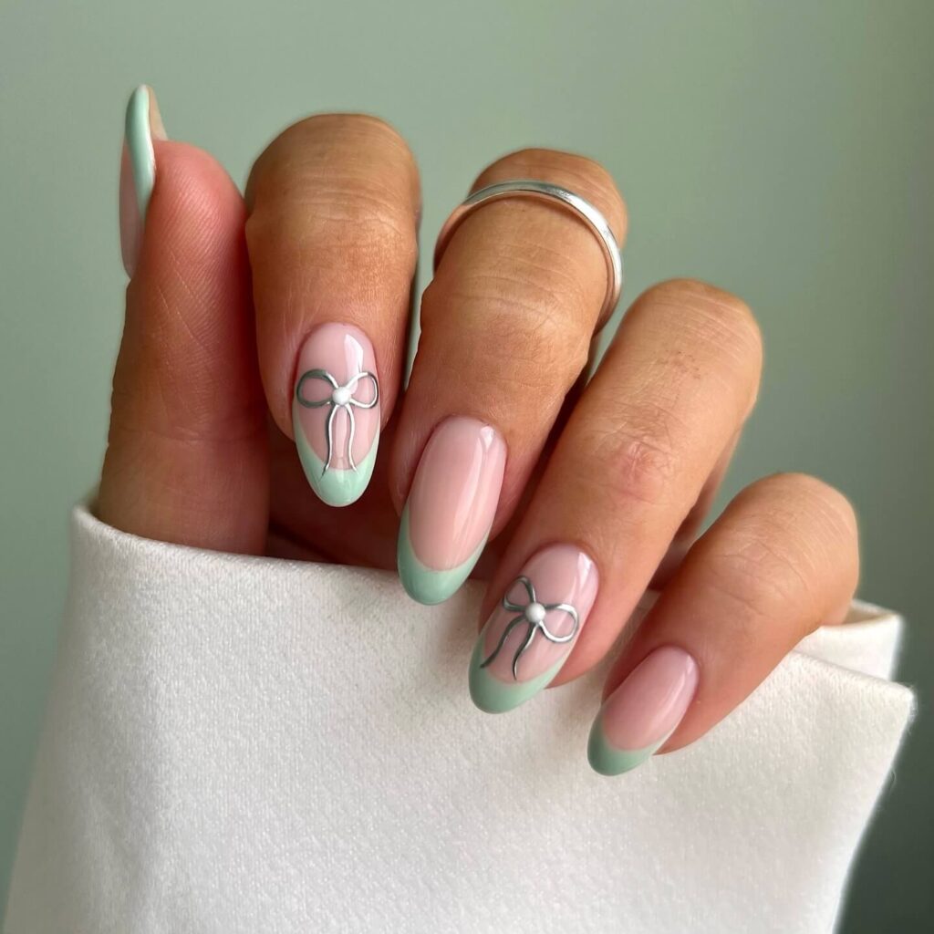 Freshly painted sage green nails with a minimalist design. This muted green nail polish trend is perfect for a subtle, nature-inspired manicure.