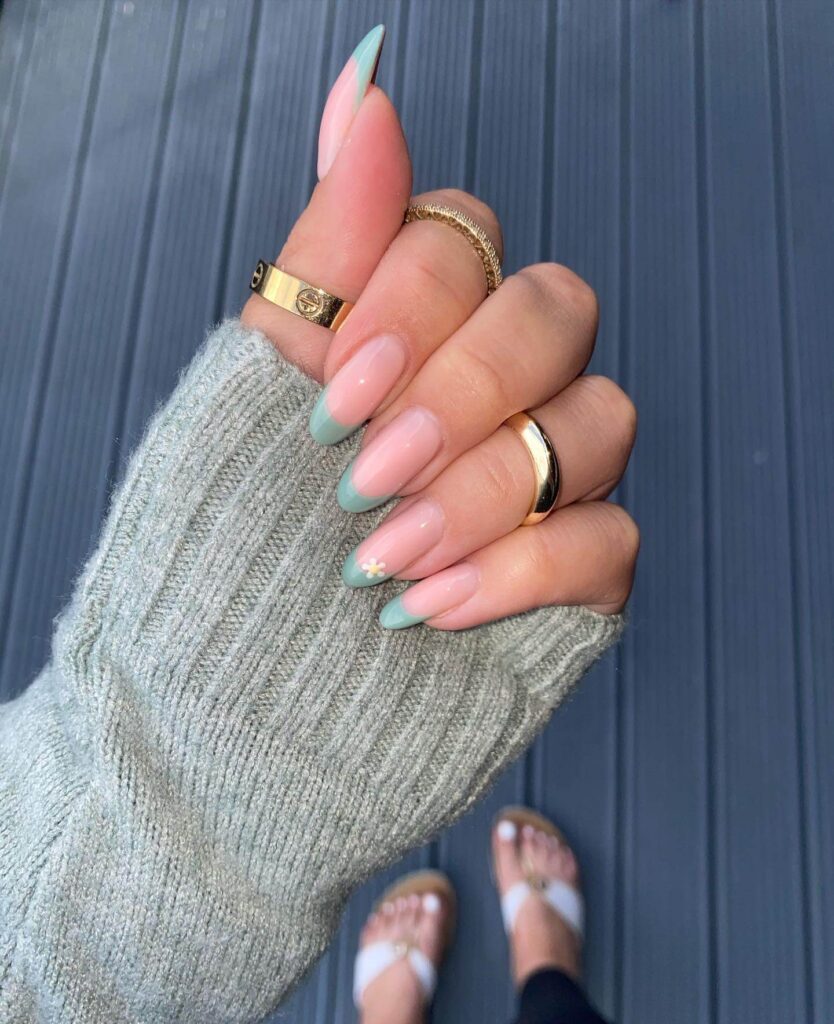 Freshly painted sage green nails with a minimalist design. This muted green nail polish trend is perfect for a subtle, nature-inspired manicure.