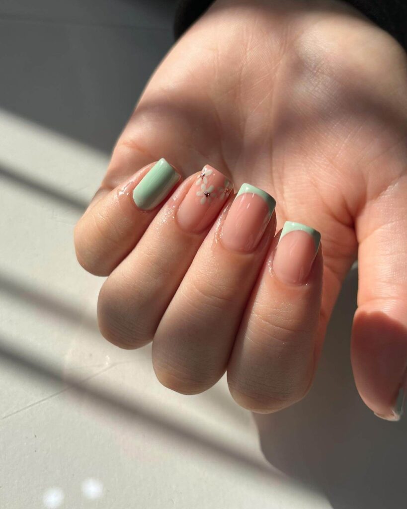 Freshly painted sage green nails with a minimalist design. This muted green nail polish trend is perfect for a subtle, nature-inspired manicure.