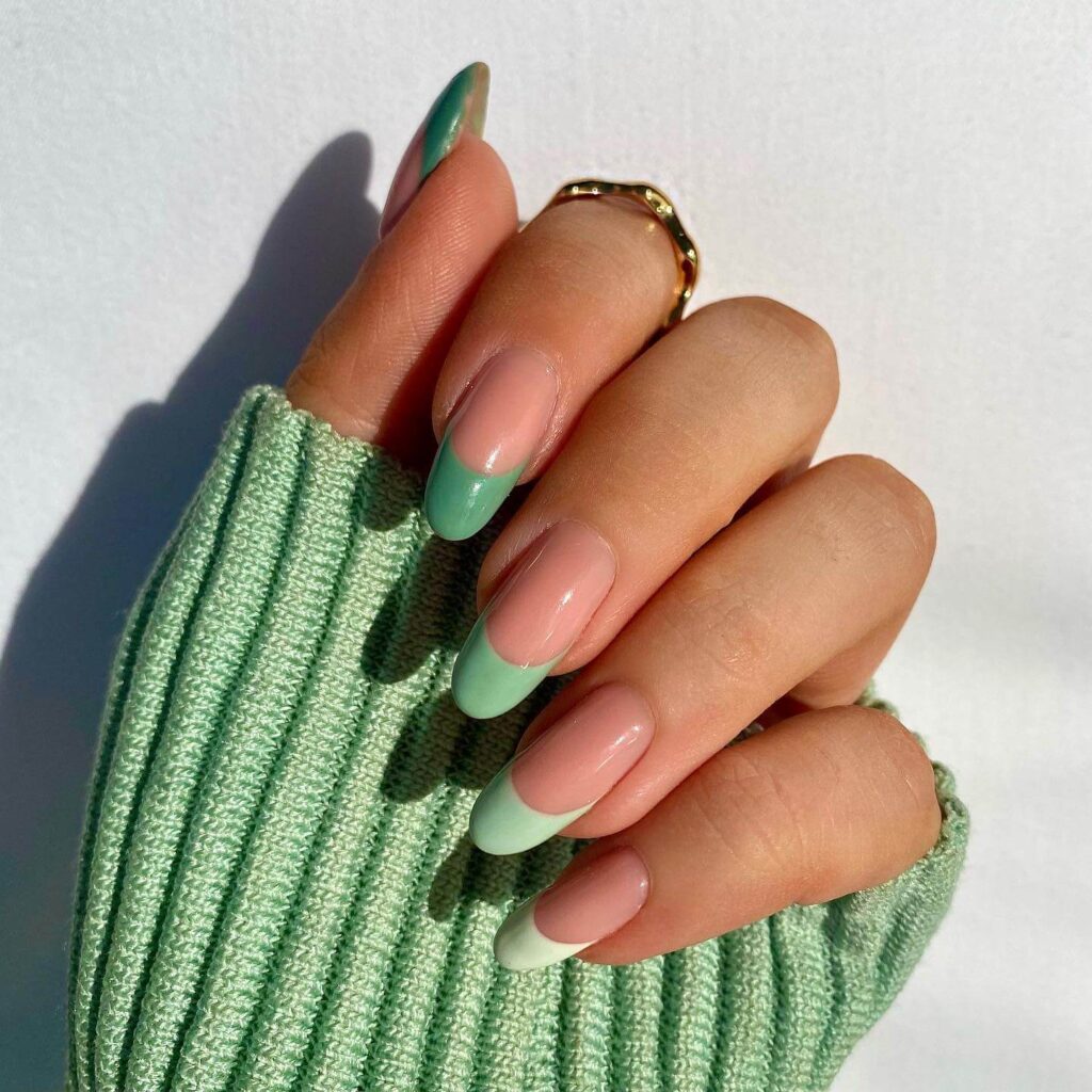 Freshly painted sage green nails with a minimalist design. This muted green nail polish trend is perfect for a subtle, nature-inspired manicure.