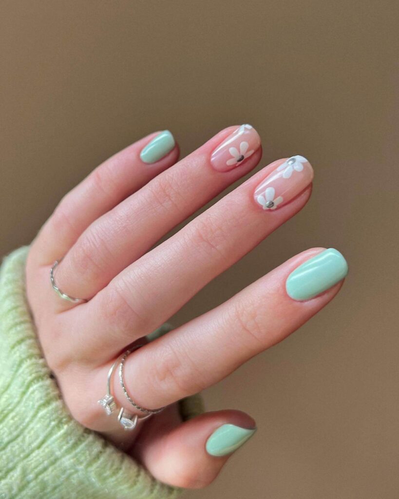 Freshly painted sage green nails with a minimalist design. This muted green nail polish trend is perfect for a subtle, nature-inspired manicure.