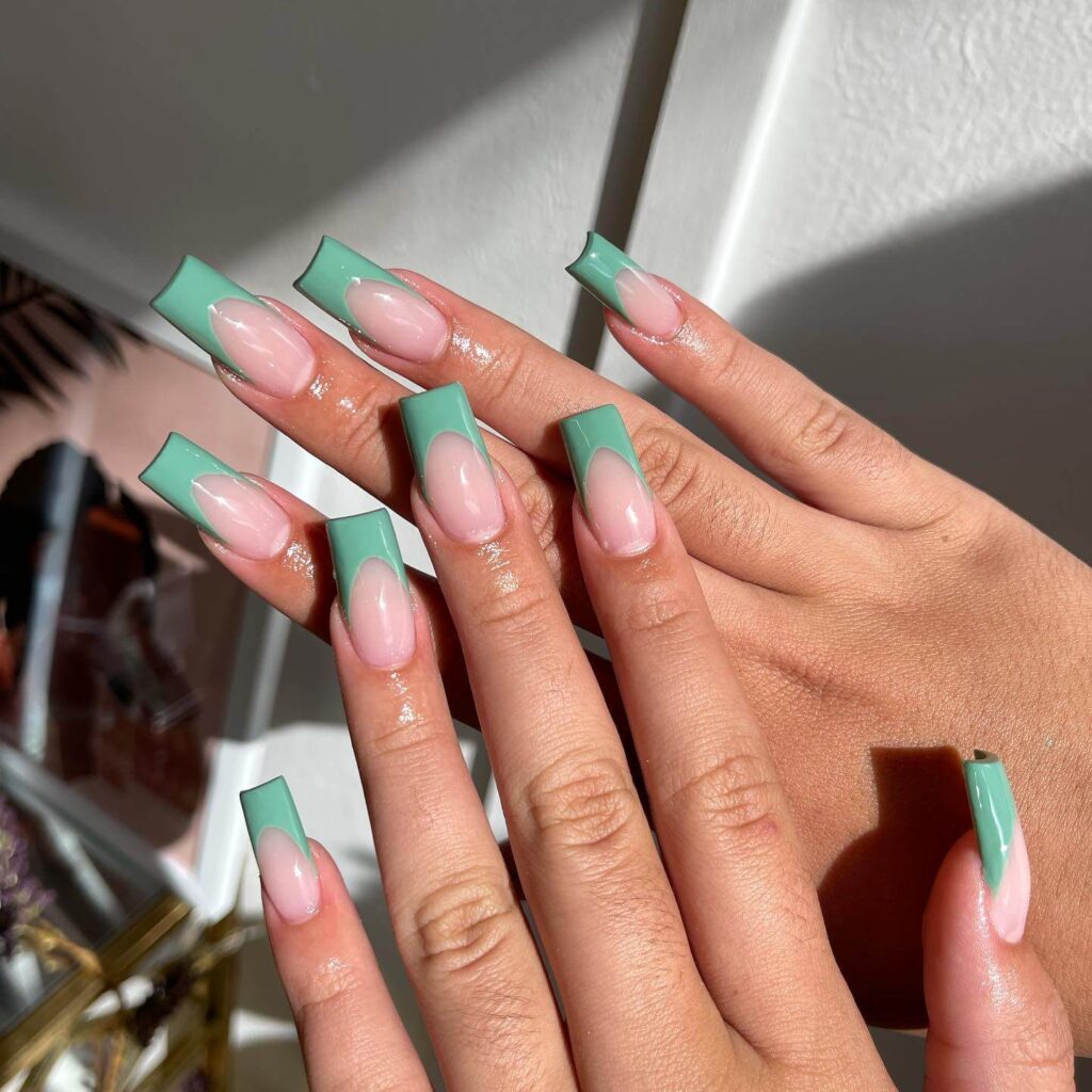 Freshly painted sage green nails with a minimalist design. This muted green nail polish trend is perfect for a subtle, nature-inspired manicure.