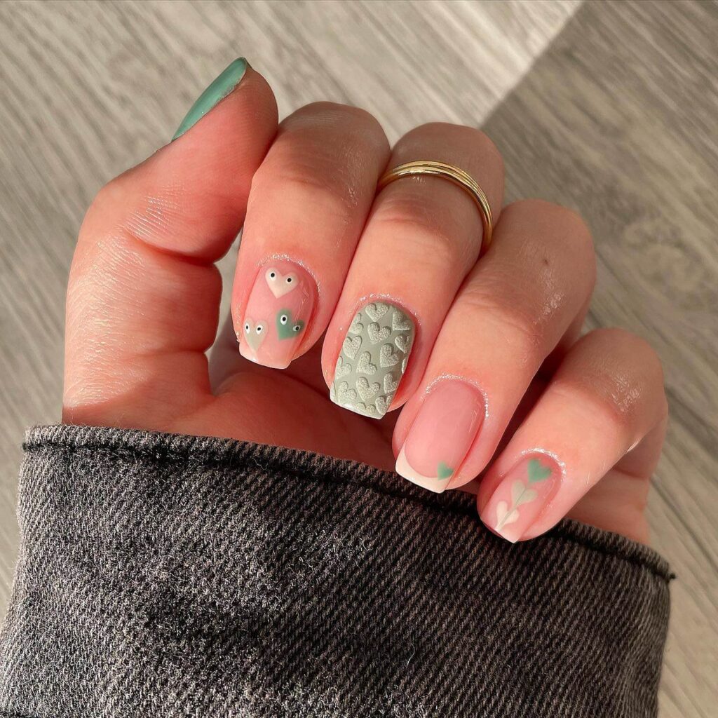 Freshly painted sage green nails with a minimalist design. This muted green nail polish trend is perfect for a subtle, nature-inspired manicure.