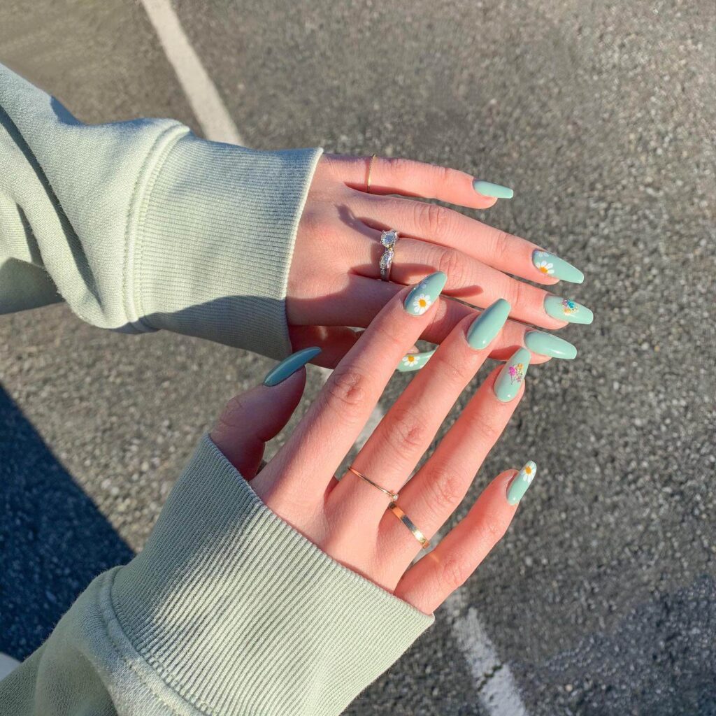 Freshly painted sage green nails with a minimalist design. This muted green nail polish trend is perfect for a subtle, nature-inspired manicure.