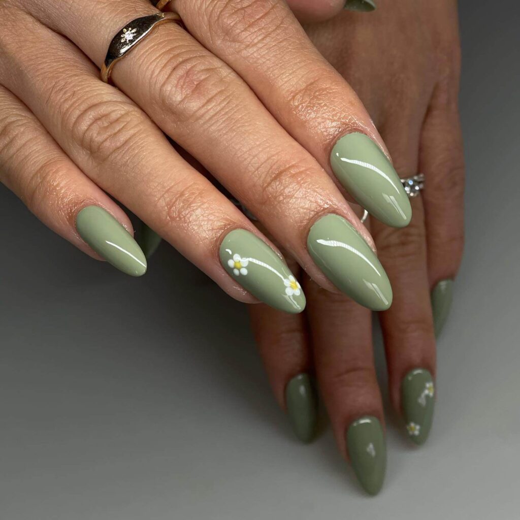 Freshly painted sage green nails with a minimalist design. This muted green nail polish trend is perfect for a subtle, nature-inspired manicure.