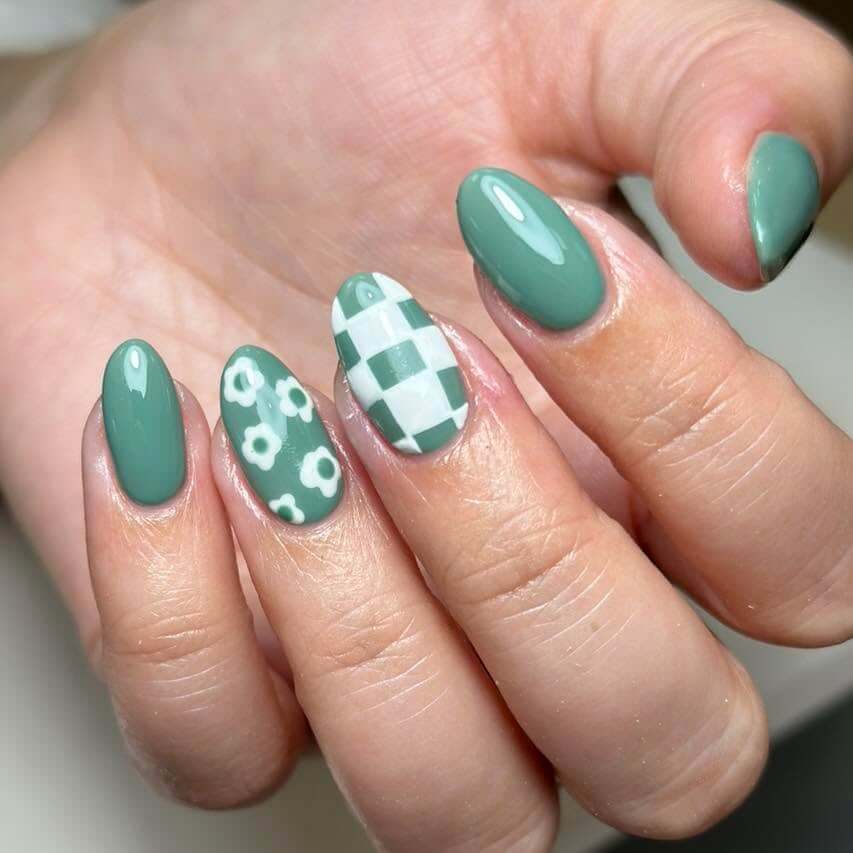 Freshly painted sage green nails with a minimalist design. This muted green nail polish trend is perfect for a subtle, nature-inspired manicure.