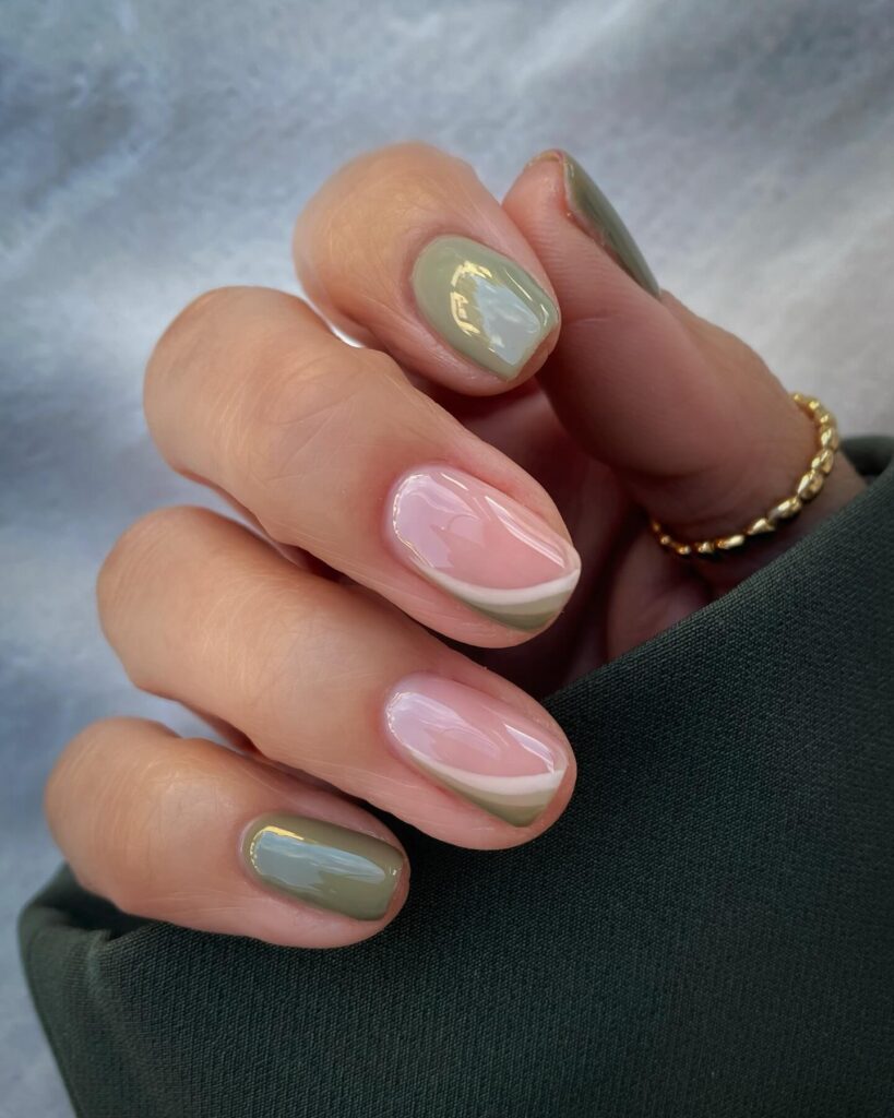 Freshly painted sage green nails with a minimalist design. This muted green nail polish trend is perfect for a subtle, nature-inspired manicure.